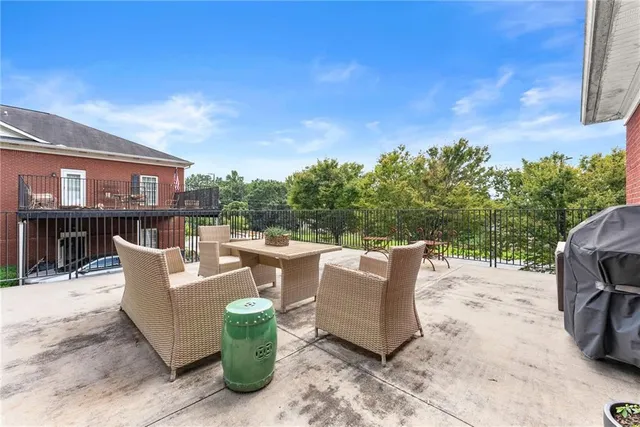a view of a patio with couches and potted plants