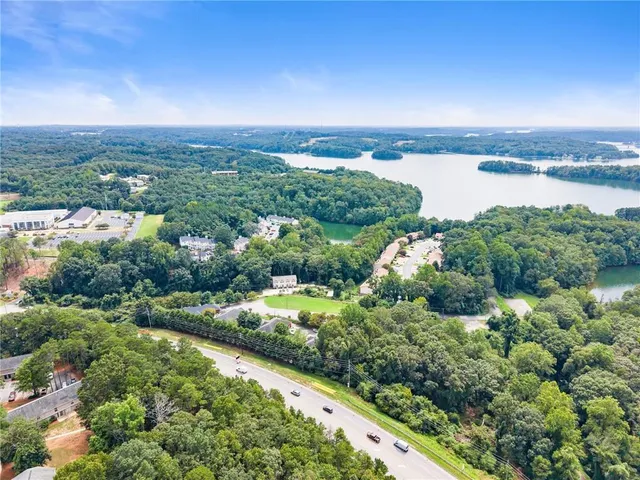 a view of a lake with houses in back