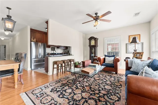 a living room with furniture wooden floor and a table