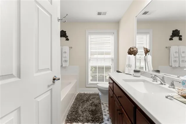 a bathroom with a sink double vanity and a tub