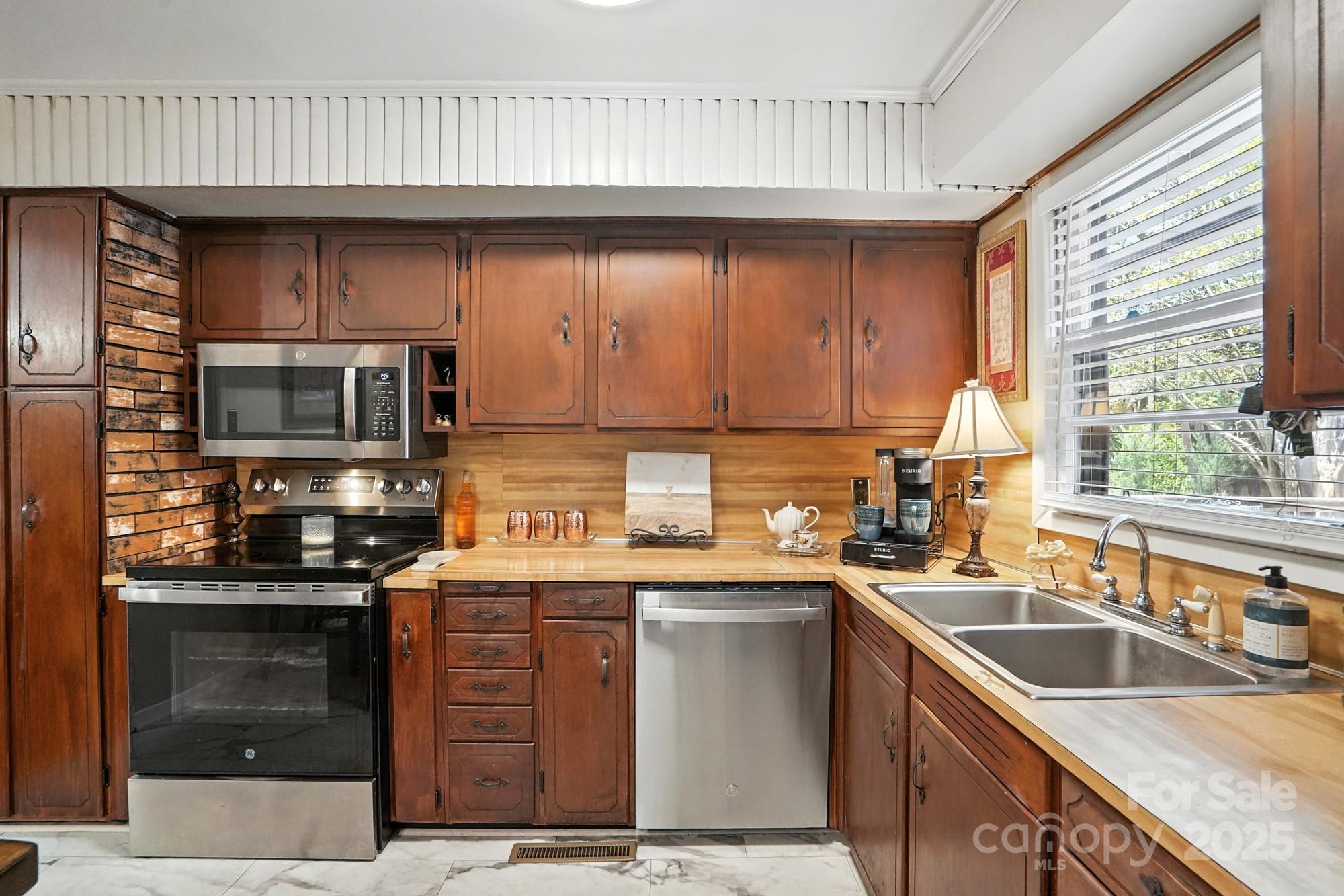 4825 Edgeland Road Edgemoor, SC 29712 - Photo 12 of 34 a kitchen with stainless steel appliances granite countertop a sink a stove and a microwave
