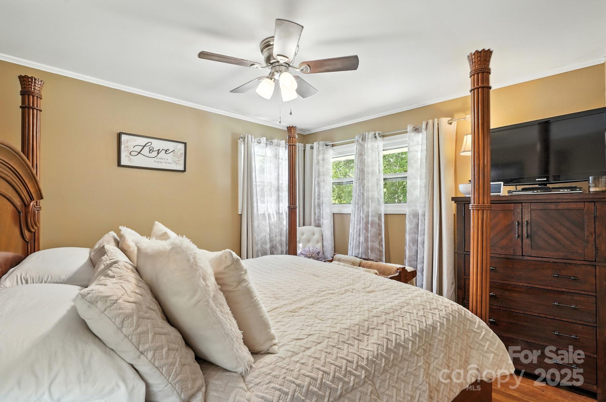 4825 Edgeland Road Edgemoor, SC 29712 - Photo 18 of 34 a bedroom with a bed and a flat screen tv