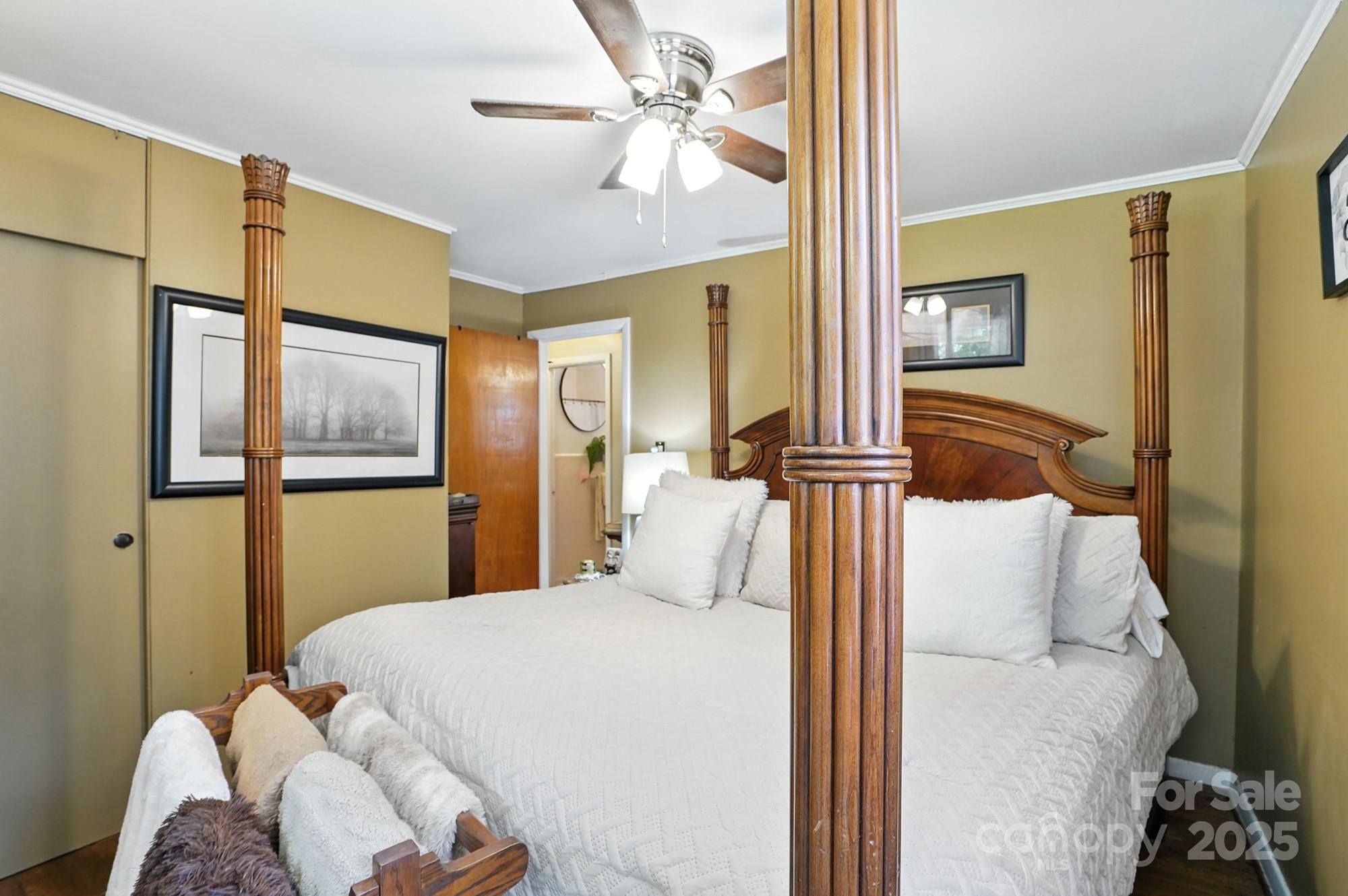 4825 Edgeland Road Edgemoor, SC 29712 - Photo 19 of 34 a bedroom with a bed and a chandelier
