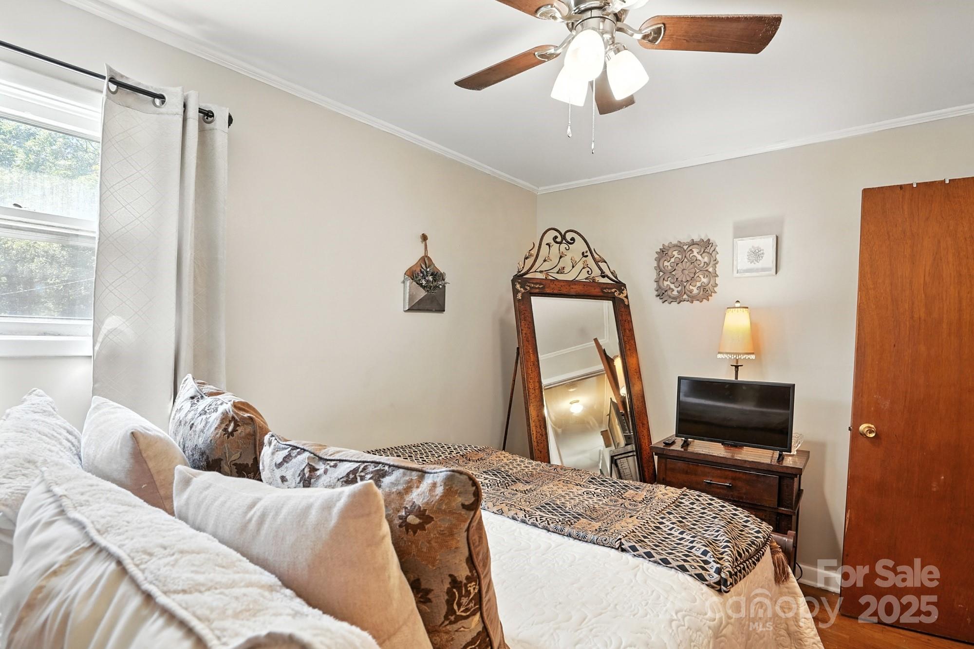 4825 Edgeland Road Edgemoor, SC 29712 - Photo 21 of 34 a bedroom with a bed and a chandelier