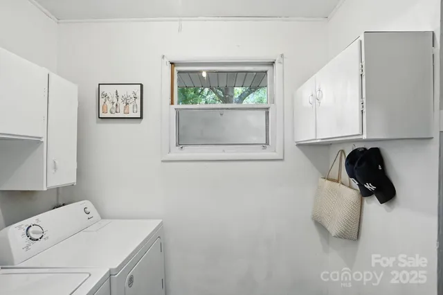 a utility room with a sink dryer and washer