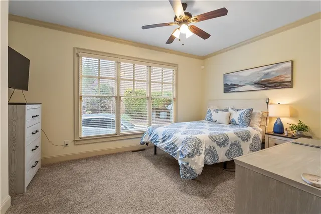a spacious bedroom with two beds and a chandelier
