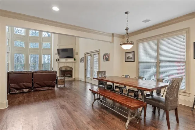 a living room with furniture a fireplace and a chandelier