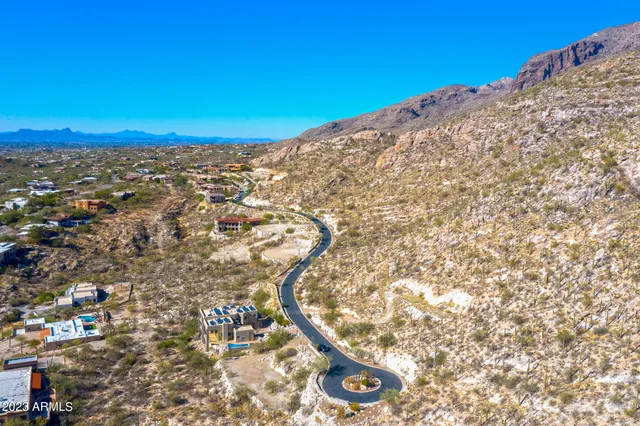 a view of a dry yard with mountains in the background