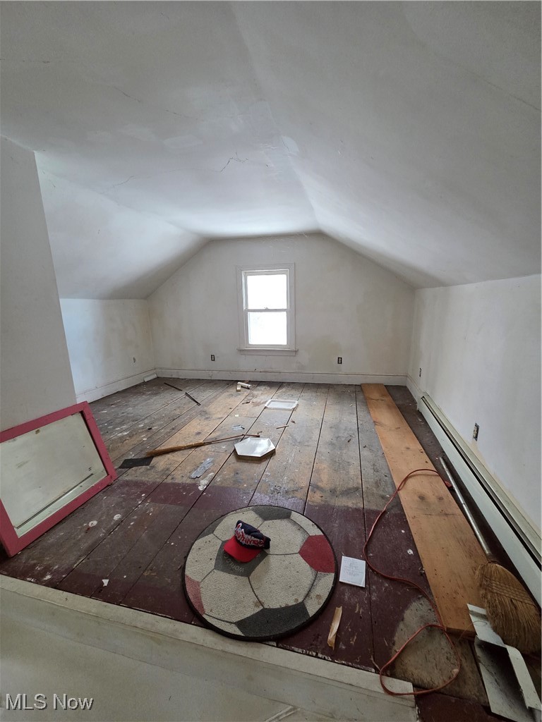 4473 Middle Ridge Road Perry, OH 44081 - Photo 16 of 22 Bonus room featuring a baseboard heating unit and wood-type flooring