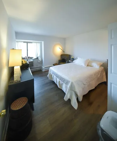 a spacious bedroom with a bed and window