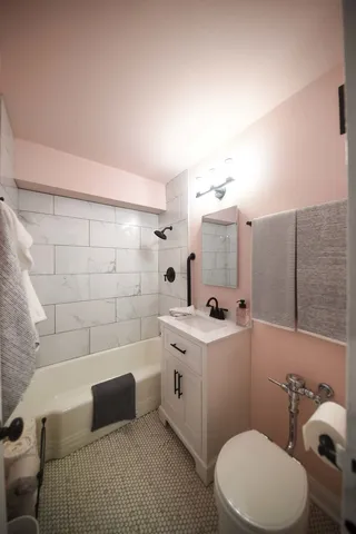 a bathroom with a sink mirror vanity and toilet