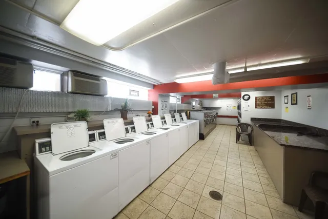 a large white kitchen with lots of appliances
