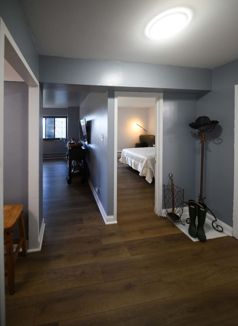 7337 South South Shore Drive, Unit 708 Chicago, IL 60649 - Photo 4 of 14 a view of a room with wooden floor and furniture