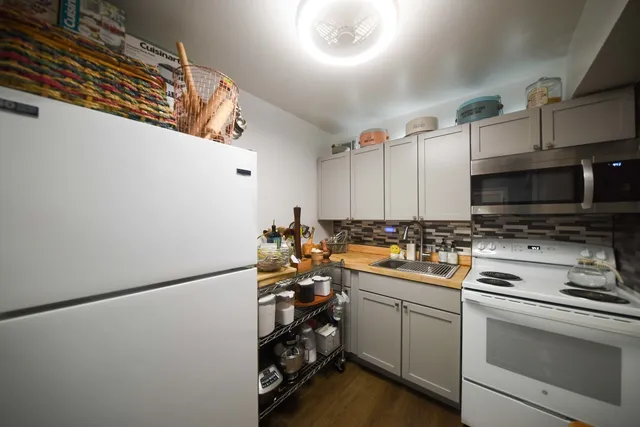 a kitchen with a sink cabinets and stainless steel appliances