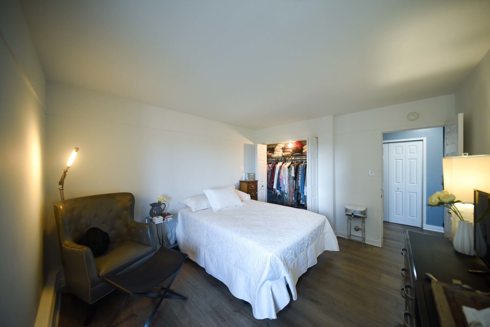 7337 South South Shore Drive, Unit 708 Chicago, IL 60649 - Photo 10 of 14 a bedroom with a bed and a chair