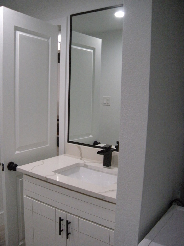 2529 Rio Grande Street, Unit 79 Austin, TX 78705 - Photo 12 of 13 a bathroom with a sink and mirror