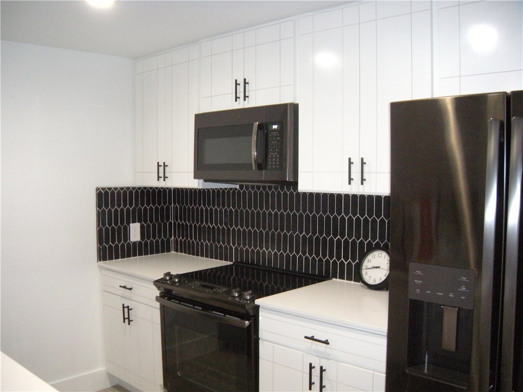 2529 Rio Grande Street, Unit 79 Austin, TX 78705 - Photo 5 of 13 a kitchen with a sink cabinets and stainless steel appliances