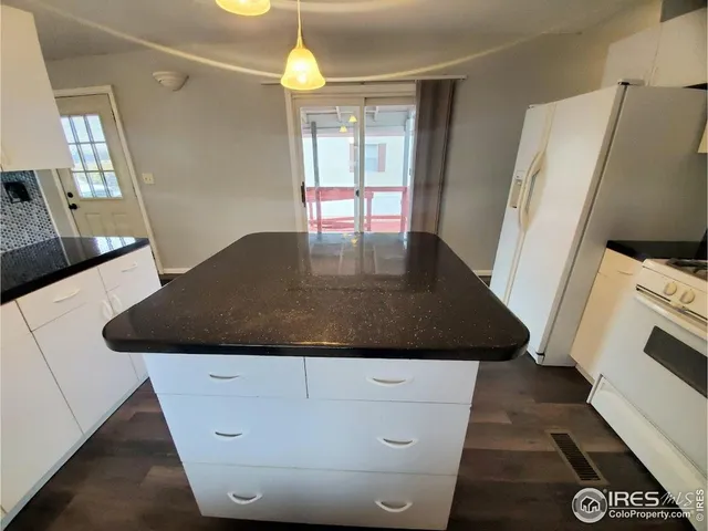 a kitchen with a sink a refrigerator and a stove
