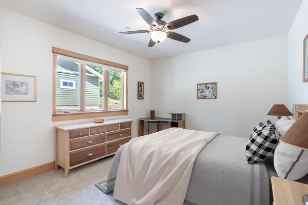 a living room with furniture and a bookshelf