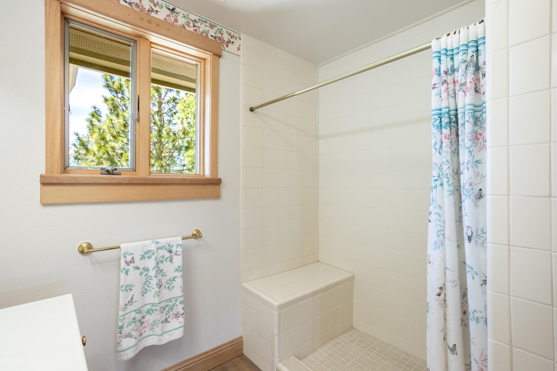 6360 Wilson Hill Road Shingletown, CA 96088 - Photo 22 of 79 a bathroom with a shower curtain and a window