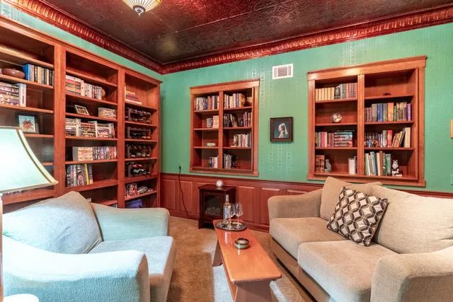 a room with water heater and wooden cabinets