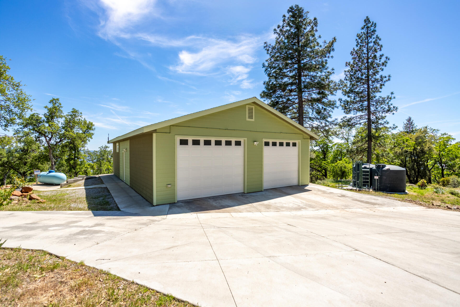 6360 Wilson Hill Road Shingletown, CA 96088 - Photo 39 of 79 a front view of a house with a yard and garage