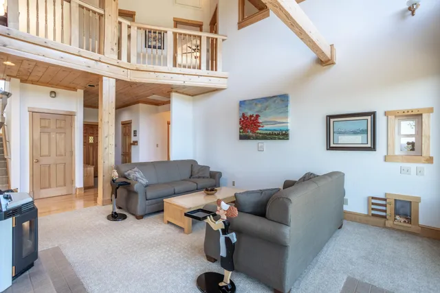 a bedroom with a bed and a dresser next to a window