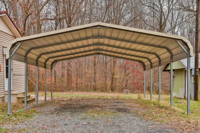 a view of a wooden door with a backyard