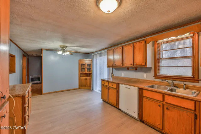 a view of a kitchen with stainless steel appliances granite countertop a sink and cabinets