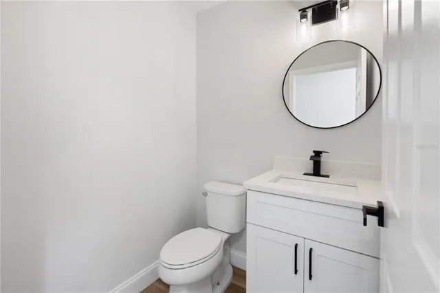 a bathroom with a toilet a sink and a mirror