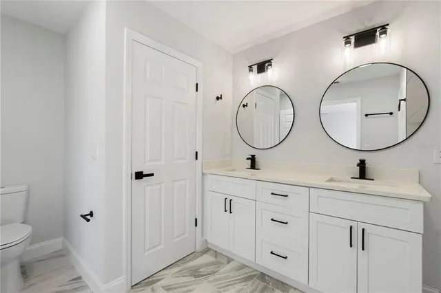 a bathroom with 2 sink and a mirror