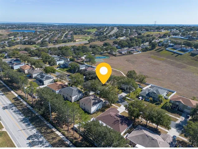 an aerial view of a house with a swimming pool yard and outdoor seating
