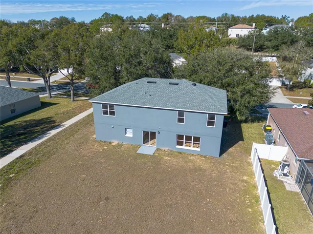 an aerial view of a house with a yard and balcony