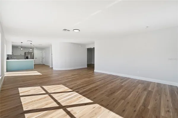 a view of a room with wooden floor and a window