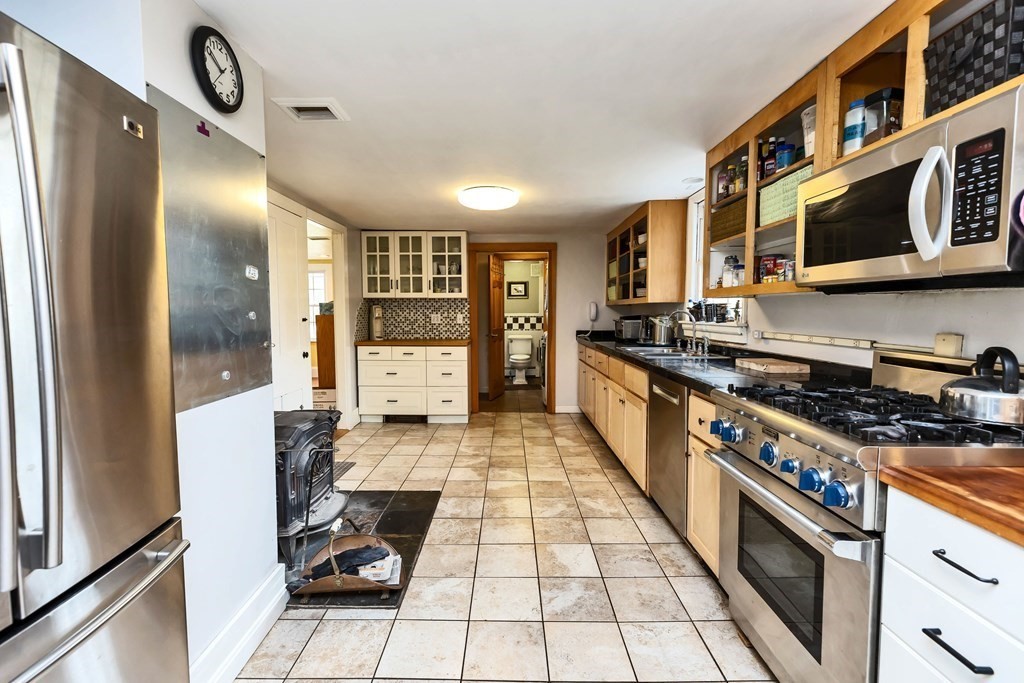 47 Taylor Road New Ipswich, NH 03071 - Photo 14 of 33 a kitchen with stainless steel appliances granite countertop a stove and a refrigerator