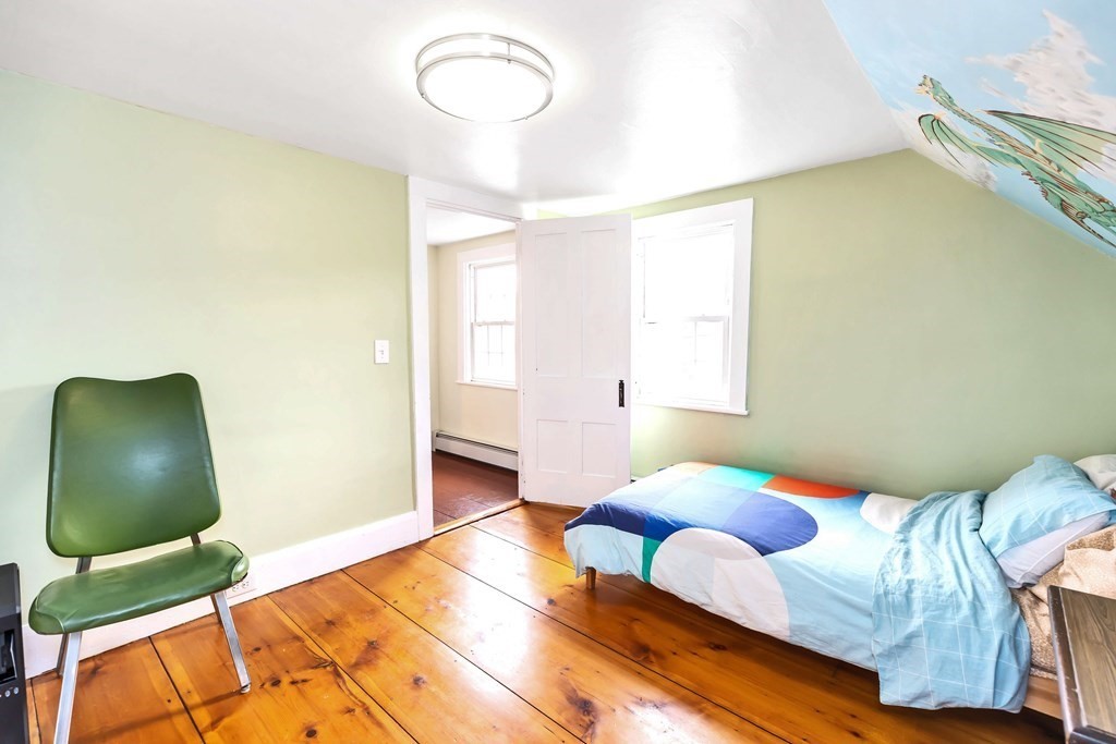 47 Taylor Road New Ipswich, NH 03071 - Photo 23 of 33 a bedroom with a bed and a chair