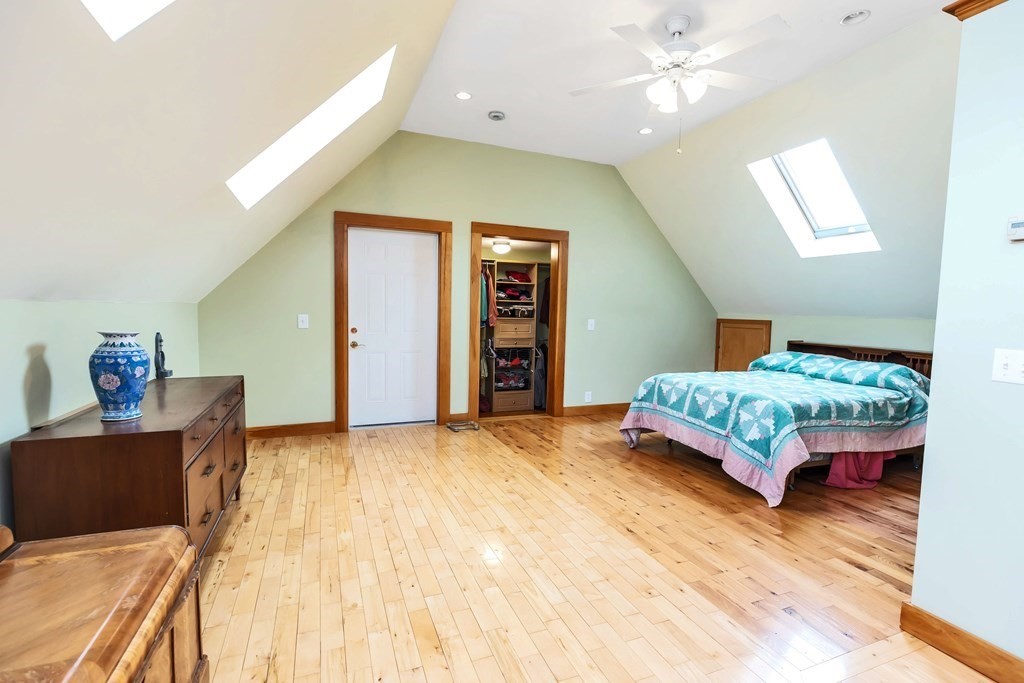 47 Taylor Road New Ipswich, NH 03071 - Photo 26 of 33 a bedroom with a bed and a chandelier