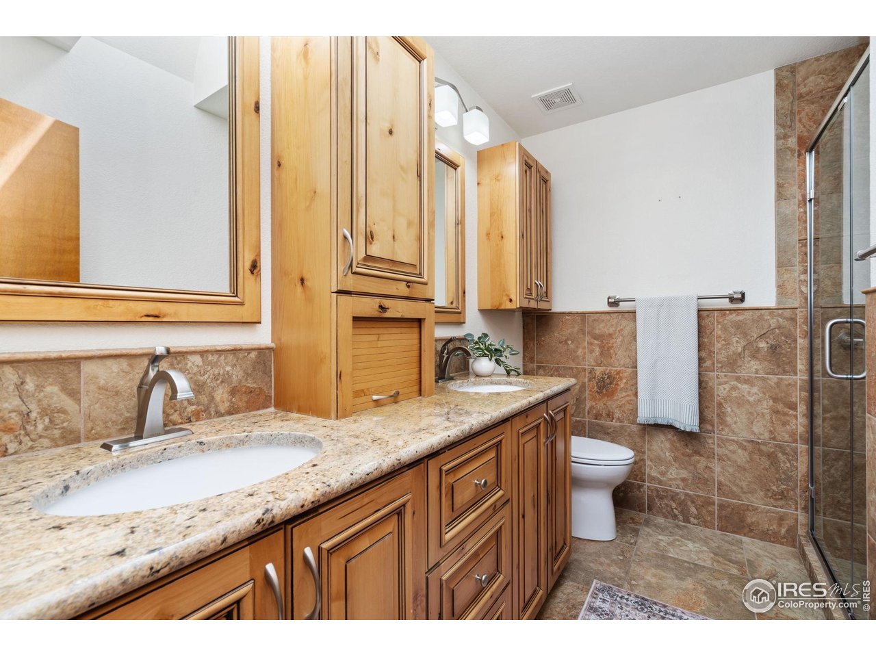 4331 West 16th Street Road Greeley, CO 80634 - Photo 24 of 41 Primary Bathroom with Custom Cabinets, Tile & Walk in Shower