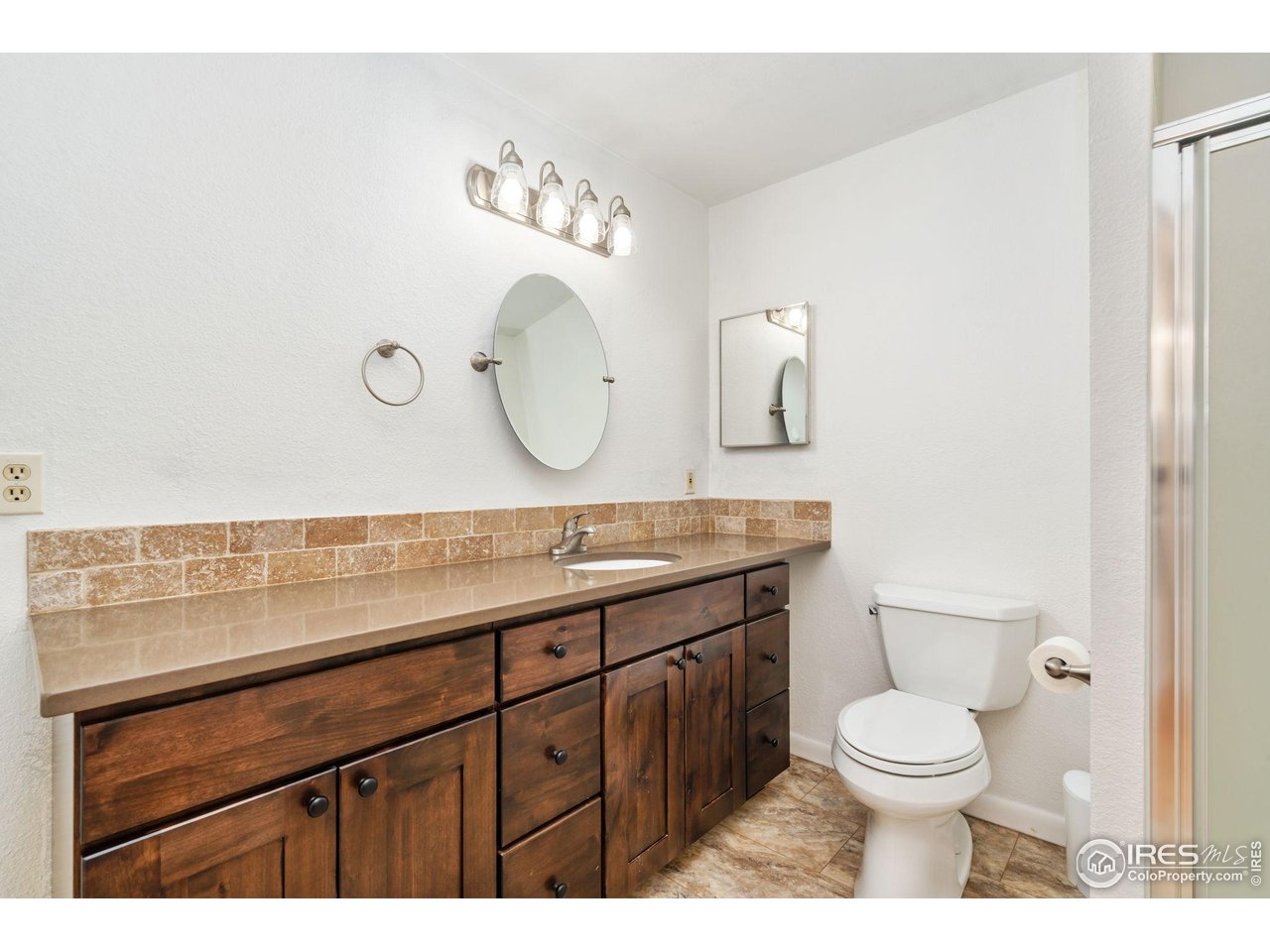 4331 West 16th Street Road Greeley, CO 80634 - Photo 29 of 41 Basement Bathroom with Custom Cabinets and Quartz Counterrops
