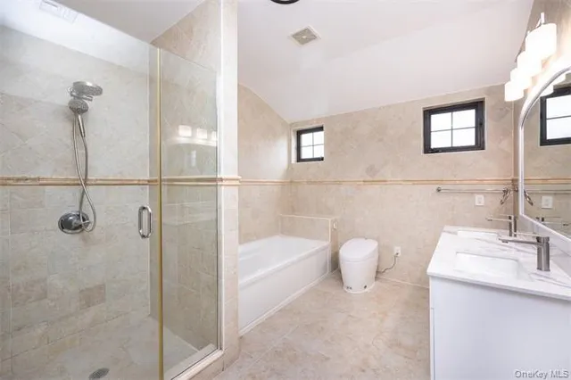 a bathroom with a granite countertop bathtub shower sink and mirror