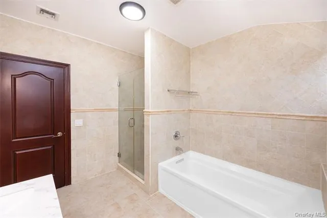 a bathroom with a bathtub and a shower