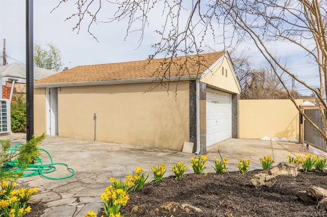 a front view of a building with a tree