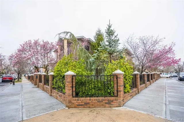a front view of a house with a garden