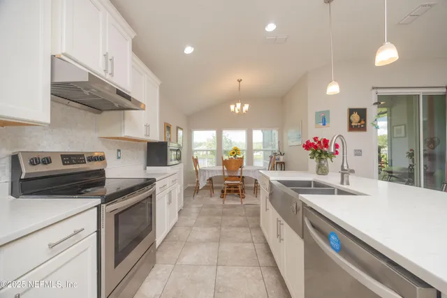 a kitchen with a sink stove and cabinets