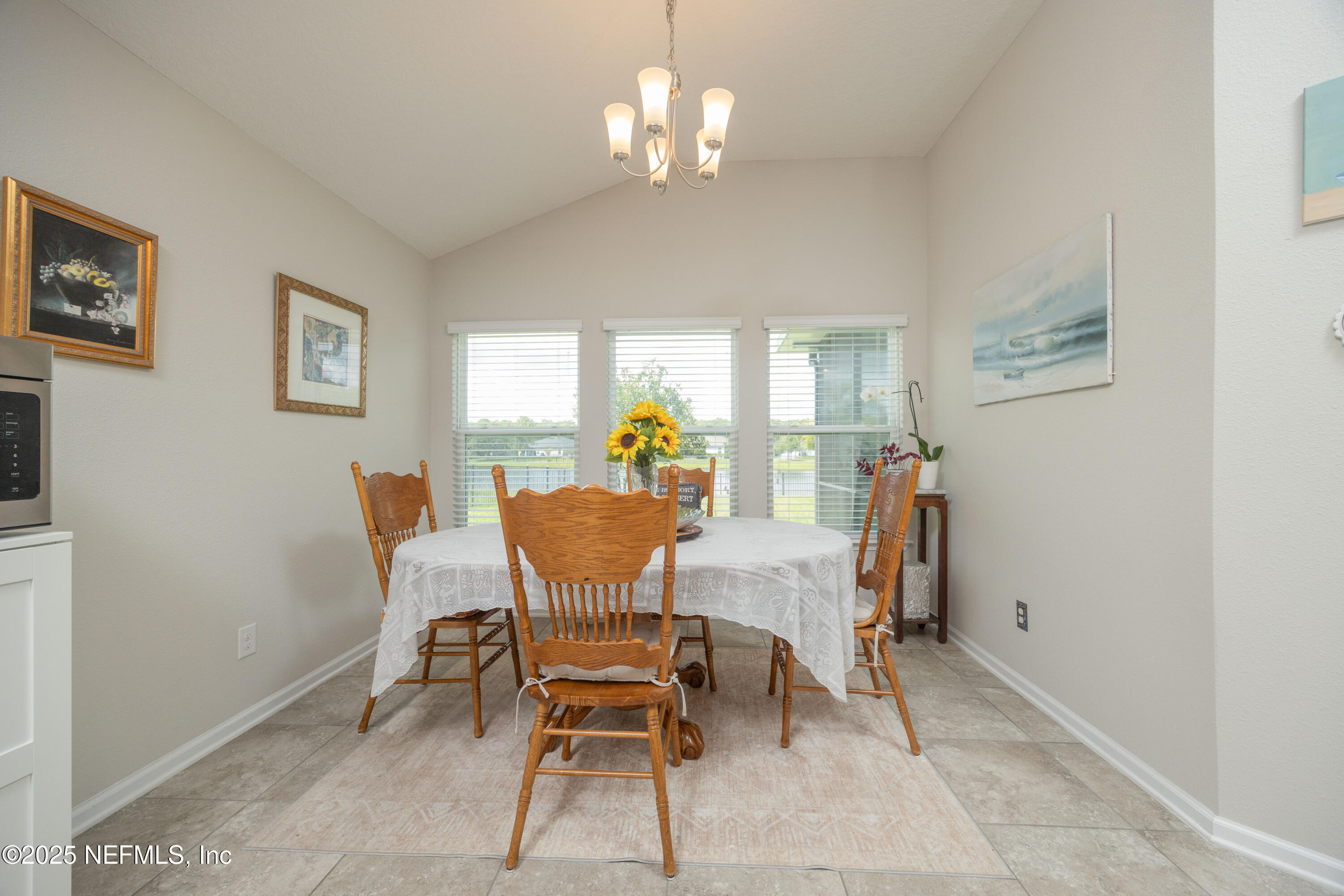 333 Old Hickory Forest Road St. Augustine, FL 32084 - Photo 19 of 62 a view of a dining room with furniture and a chandelier