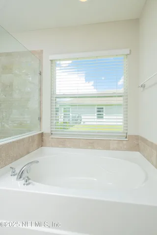 an empty room with wooden floor cabinet and a flat screen tv