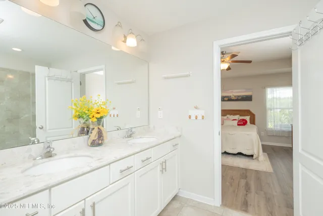 a bathroom with a granite countertop sink a toilet and shower