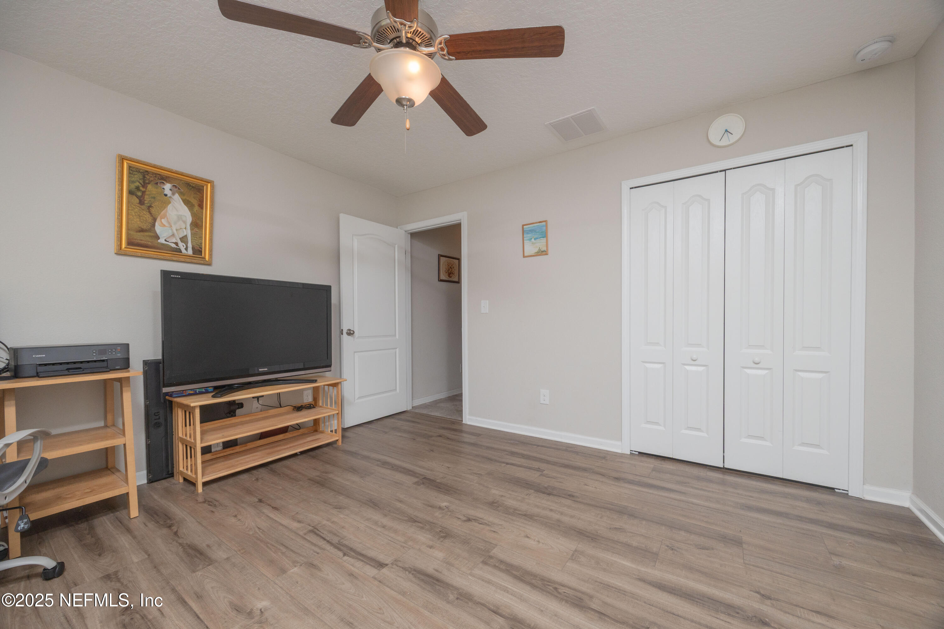 333 Old Hickory Forest Road St. Augustine, FL 32084 - Photo 28 of 62 an empty room with wooden floor cabinet and a flat screen tv