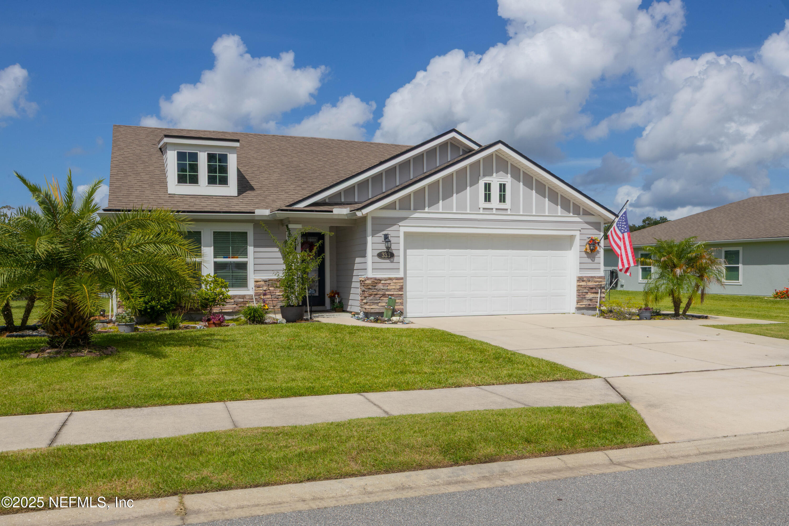333 Old Hickory Forest Road St. Augustine, FL 32084 - Photo 5 of 62 a view of a white house with a small yard and large trees