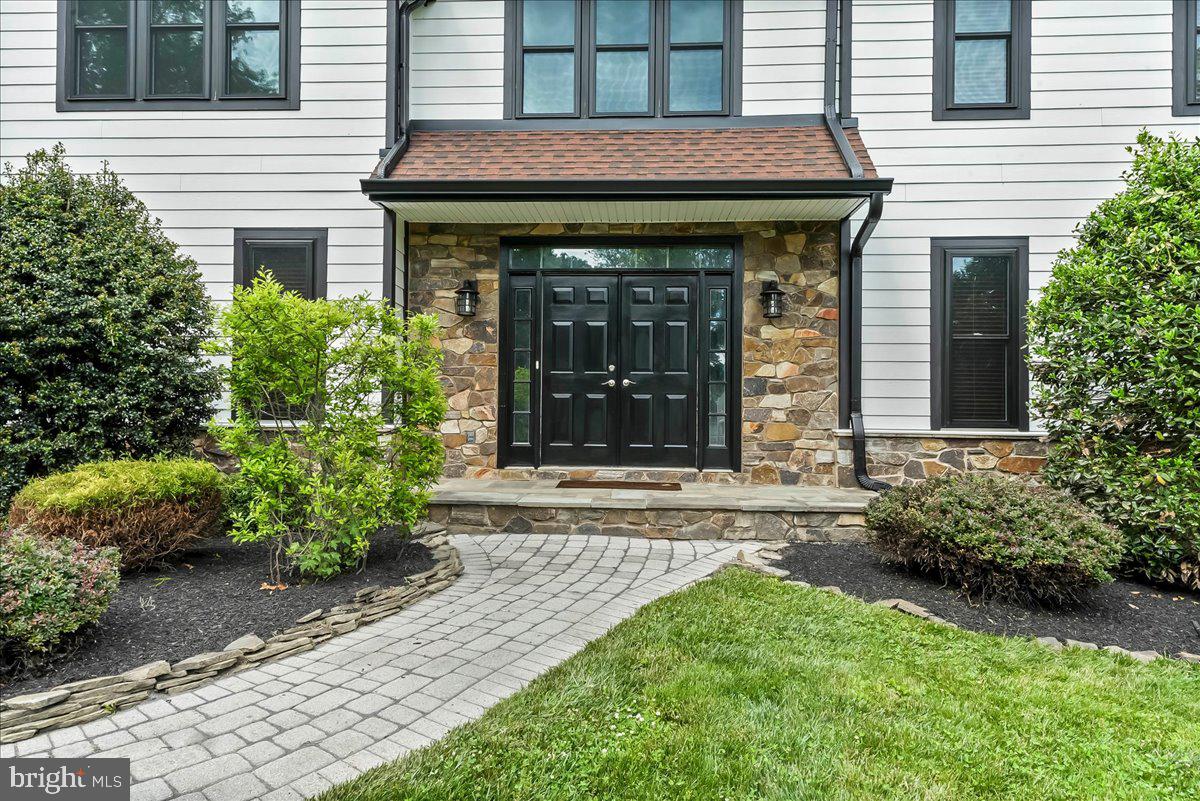 51 Ridings Way Chadds Ford, PA 19317 - Photo 5 of 57 a view of a house with potted plants and a chair